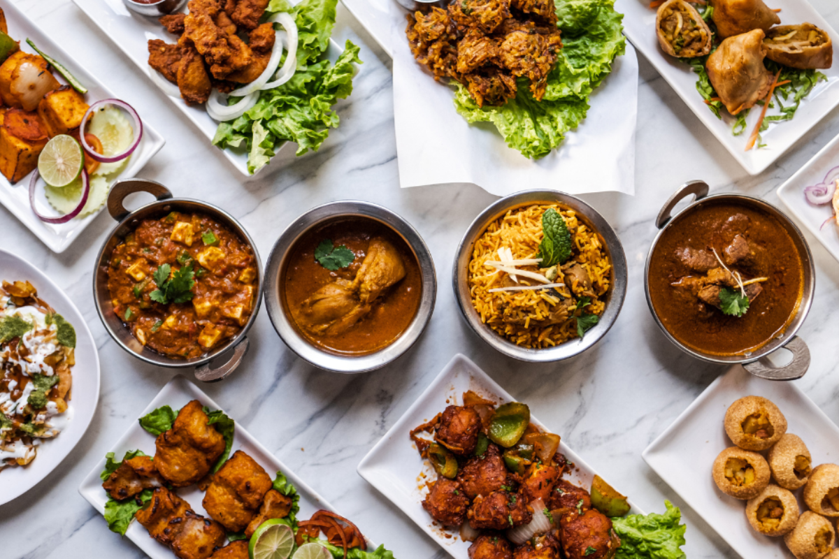 Displays a variety of finished food dishes.